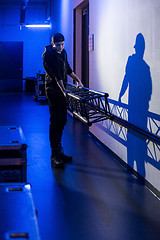 Image showing Roadie carrying a big truss support