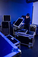 Image showing Roadie unpacking a dj mixing table