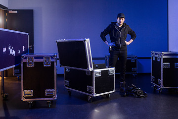 Image showing Roadie standing next to an unpacked flightcase