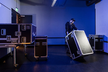 Image showing Roadie tipping over a flightcase