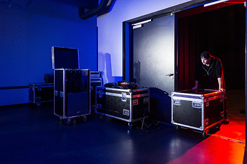 Image showing Roadie rolling a flightcase off the stage