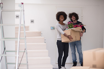 Image showing multiethnic couple moving into a new home