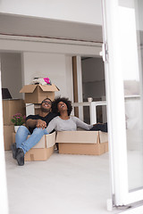 Image showing African American couple  playing with packing material