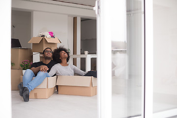 Image showing African American couple  playing with packing material