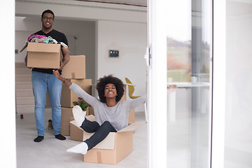 Image showing African American couple  playing with packing material