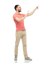 Image showing happy man touching something imaginary