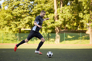 Image showing soccer player playing with ball on football field