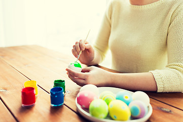 Image showing close up of woman hands coloring easter eggs