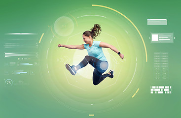 Image showing happy smiling sporty young woman jumping in air