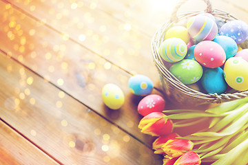 Image showing close up of easter eggs in basket and flowers