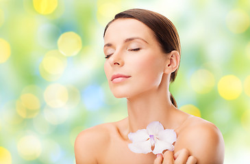 Image showing beautiful young woman with orchid flower