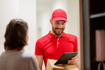 Image showing deliveryman with tablet pc and box at customer