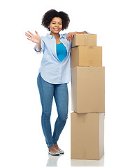 Image showing happy african woman with parcel boxes waving hand