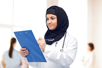 Image showing muslim female doctor in hijab with clipboard