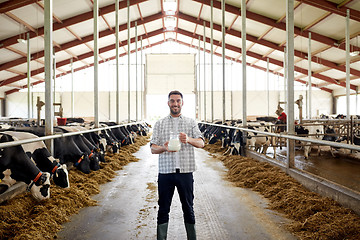 Image showing man or farmer with cows milk on dairy farm