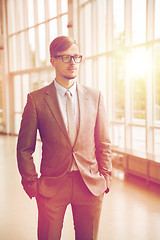 Image showing young businessman in suit and glasses at office