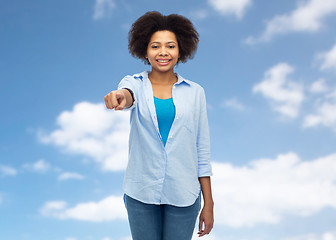 Image showing happy african woman pointing finger to you