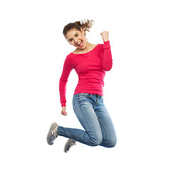 Image showing smiling young woman jumping in air