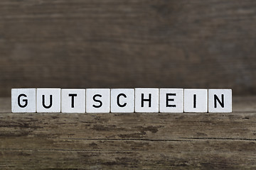 Image showing German word voucher, written in cubes