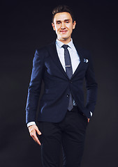 Image showing young pretty business man standing on black background, modern h