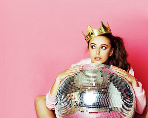 Image showing young cute disco girl on pink background with disco ball and cro