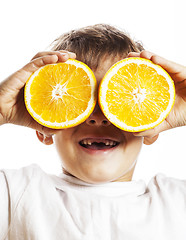 Image showing little cute boy with orange fruit double isolated on white smili