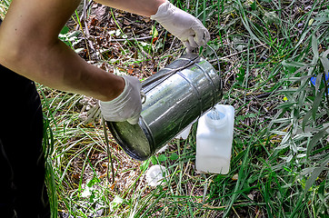 Image showing Take samples of water for laboratory testing. The concept - analysis of water purity, environment, ecology.