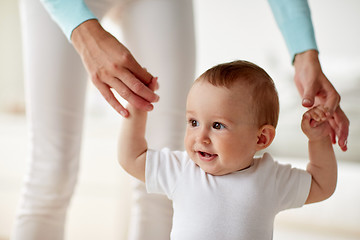 Image showing happy baby learning to walk with mother help