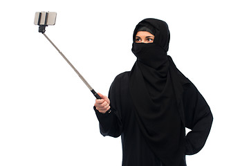 Image showing muslim woman in hijab taking selfie by smartphone