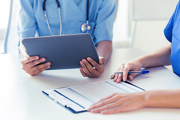 Image showing close up of doctors with tablet pc at hospital