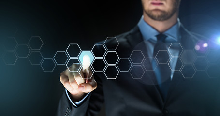 Image showing businessman touching virtual hexagonal projection