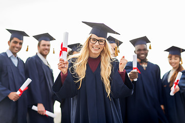 Image showing happy student with diploma celebrating graduation