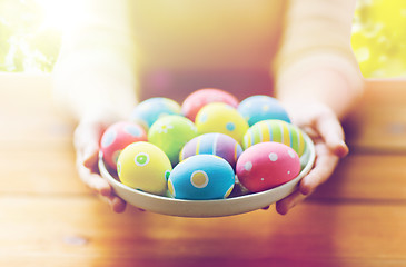 Image showing close up of woman hands with colored easter eggs