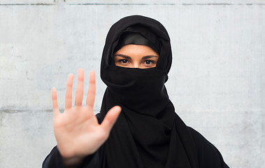 Image showing muslim woman in hijab showing stop sign