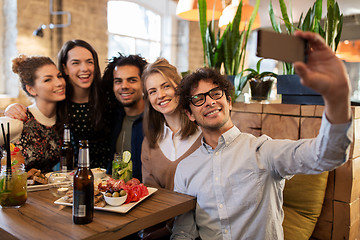 Image showing friends taking selfie by smartphone at bar or cafe