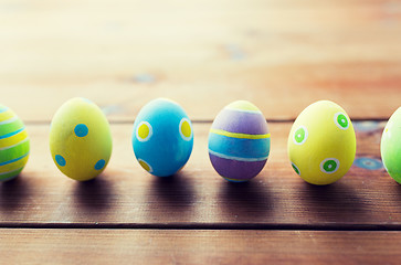 Image showing close up of colored easter eggs on wooden surface