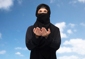 Image showing praying muslim woman in hijab over white