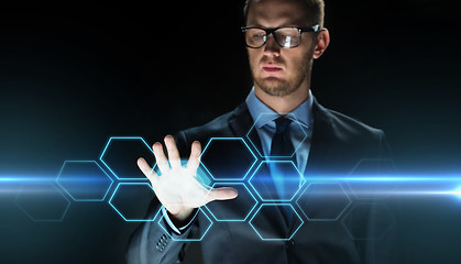 Image showing businessman touching virtual hexagonal projection