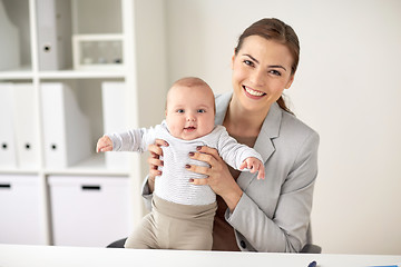 Image showing happy businesswoman with baby at office