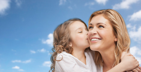 Image showing happy little girl hugging and kissing her mother