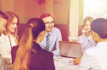 Image showing architects with laptop and blueprint at office