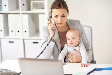 Image showing businesswoman with baby calling on phone at office