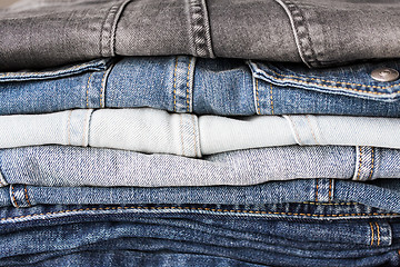 Image showing close up of denim clothes or jeans pile