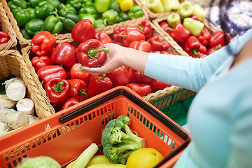 Image showing woman with basket buying peppers at grocery store