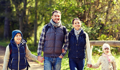 Image showing happy family with backpacks hiking