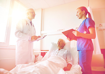 Image showing doctor and nurse visiting senior woman at hospital