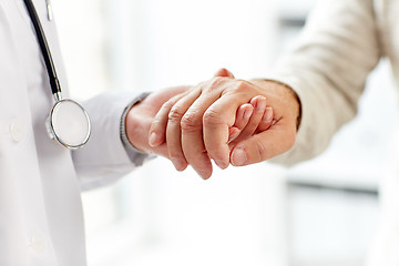 Image showing close up of doctor holding old man hand