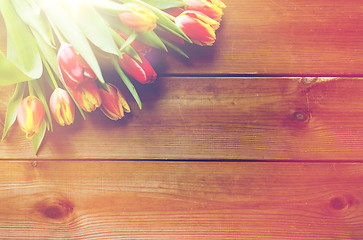 Image showing close up of tulip flowers on wooden table