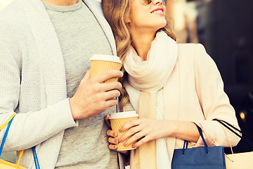 Image showing close up of couple with shopping bags and coffee