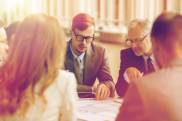 Image showing architects with blueprint and tablet pc at office